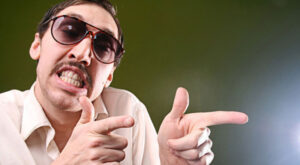 image of a man with slicked back hair and sunglasses